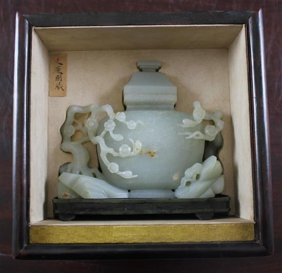 A Chinese pale celadon jade vase and cover, with spinach green jade stand, Qing dynasty or later, 4.3cm., width 13.5cm., fitted rosewoo